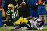 GREEN BAY, WI - NOVEMBER 14: Charles Woodson #21 of the Green Bay Packers intercepts the football as he is tackled by Devin Aromashadu #19 of the Minnesota Vikings at Lambeau Field on November 14, 2011 in Green Bay, Wisconsin. (Photo by Scott Boehm/Getty Images)