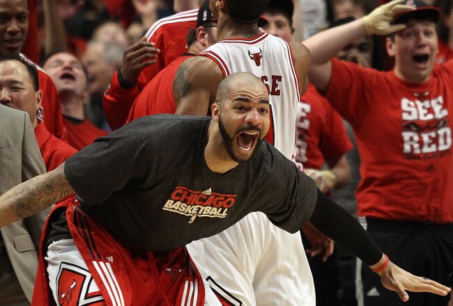CHICAGO, IL - MAY 15:  Carlos Boozer #5 of the Chicago Bulls celebrates on the bench against the Miami Heat in Game One of the Eastern Conference Finals during the 2011 NBA Playoffs on May 15, 2011 at the United Center in Chicago, Illinois. NOTE TO USER: User expressly acknowledges and agrees that, by downloading and or using this photograph, User is consenting to the terms and conditions of the Getty Images License Agreement  (Photo by Jonathan Daniel/Getty Images)
