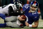 EAST RUTHERFORD, NJ - DECEMBER 13:  Eli Manning #10 of the New York Giants gets sacked late in the game by Will Witherspoon #50 of the Philadelphia Eagles at Giants Stadium on December 13, 2009 in East Rutherford, New Jersey.  (Photo by Nick Laham/Getty Images)