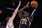 OAKLAND, CA - JANUARY 07:  Paul Millsap #24 of the Utah Jazz shoots over David Lee #10 of the Golden State Warriors at Oracle Arena on January 7, 2012 in Oakland, California.  NOTE TO USER: User expressly acknowledges and agrees that, by downloading and or using this photograph, User is consenting to the terms and conditions of the Getty Images License Agreement.  (Photo by Ezra Shaw/Getty Images)