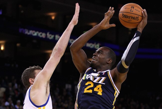 OAKLAND, CA - JANUARY 07:  Paul Millsap #24 of the Utah Jazz shoots over David Lee #10 of the Golden State Warriors at Oracle Arena on January 7, 2012 in Oakland, California.  NOTE TO USER: User expressly acknowledges and agrees that, by downloading and or using this photograph, User is consenting to the terms and conditions of the Getty Images License Agreement.  (Photo by Ezra Shaw/Getty Images)