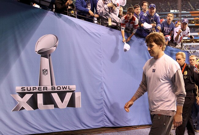 INDIANAPOLIS, IN - FEBRUARY 05:  Quarterback Eli Manning #10 of the New York Giants walks off the field during warmups before the New York Giants take on the New England Patriots in Super Bowl XLVI at Lucas Oil Stadium on February 5, 2012 in Indianapolis, Indiana.  (Photo by Ezra Shaw/Getty Images)