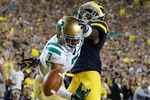 ANN ARBOR, MI - SEPTEMBER 10:  TJ Jones #7 of the Notre Dame Fighting Irish can't pull in a pass around the defense of Courtney Avery #5 of the Michigan Wolverines at Michigan Stadium on September 10, 2010 in Ann Arbor, Michigan. Avery was called for pass interference. Michigan won the game 35-31. (Photo by Gregory Shamus/Getty Images)