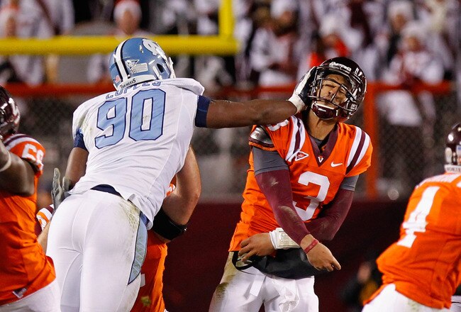 BLACKSBURG, VA - NOVEMBER 17: Logan Thomas #3 of the Virginia Tech Hokies is struck in the head after throwing the ball by Quinton Coples #90 of the North Carolina Tar Heels at Lane Stadium on November 17, 2011 in Blacksburg, Virginia. (Photo by Geoff Burke/Getty Images)