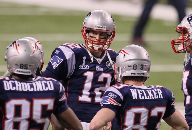 INDIANAPOLIS, IN - FEBRUARY 05:  Tom Brady #12 of the New England Patriots works with his receivers on the field before the New England Patriots take on the New York Giants in Super Bowl XLVI at Lucas Oil Stadium on February 5, 2012 in Indianapolis, Indiana.  (Photo by Jeff Gross/Getty Images)