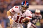 INDIANAPOLIS, IN - FEBRUARY 05:  Quarterback Eli Manning #10 of the New York Giants hands the ball off during the game against the New England Patriots during Super Bowl XLVI at Lucas Oil Stadium on February 5, 2012 in Indianapolis, Indiana.  (Photo by Jamie Squire/Getty Images)