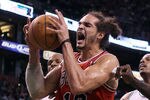 BOSTON, MA - JANUARY 13:  Joakim Noah #13 of the Chicago Bulls celebrates a basket in the fourth quarter against the Boston Celtics on January 13, 2012 at TD Garden in Boston, Massachusetts. The Chicago Bulls defeated the Boston Celtics 79-88. NOTE TO USER: User expressly acknowledges and agrees that, by downloading and or using this photograph, User is consenting to the terms and conditions of the Getty Images License Agreement.  (Photo by Elsa/Getty Images)
