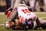 INDIANAPOLIS, IN - FEBRUARY 05:  Quarterback Tom Brady #12 of the New England Patriots is sacked by Justin Tuck #91 of the New York Giants in the second half during Super Bowl XLVI at Lucas Oil Stadium on February 5, 2012 in Indianapolis, Indiana.  (Photo by Ezra Shaw/Getty Images)