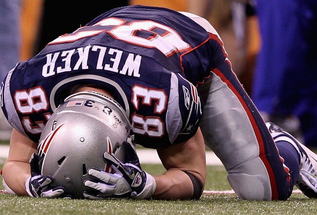 INDIANAPOLIS, IN - FEBRUARY 05:  Wes Welker #83 of the New England Patriots lays on the ground in the fourth quarter during Super Bowl XLVI at Lucas Oil Stadium on February 5, 2012 in Indianapolis, Indiana.  (Photo by Elsa/Getty Images)