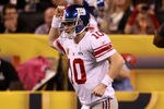 INDIANAPOLIS, IN - FEBRUARY 05:  Quarterback Eli Manning #10 of the New York Giants celebrates after his first quarter touchdown pass to Victor Cruz #80 against the New England Patriots during Super Bowl XLVI at Lucas Oil Stadium on February 5, 2012 in Indianapolis, Indiana. Manning, named MVP, led the Giants to a 21-17 victory.  (Photo by Win McNamee/Getty Images)