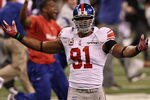 INDIANAPOLIS, IN - FEBRUARY 05:  Justin Tuck #91 of the New York Giants celebrates after defeating the New England Patriots 21-17 during Super Bowl XLVI at Lucas Oil Stadium on February 5, 2012 in Indianapolis, Indiana.  (Photo by Win McNamee/Getty Images)