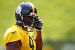 LATROBE, PA - JULY 29:  James Harrison #92 of the Pittsburgh Steelers snaps in his chin guard during training camp on July 29, 2011 at St Vincent College in Latrobe, Pennsylvania.  (Photo by Jared Wickerham/Getty Images)