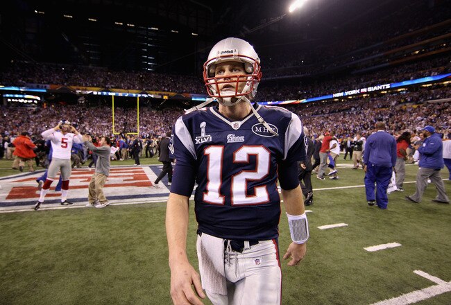 INDIANAPOLIS, IN - FEBRUARY 05:  Tom Brady #12 of the New England Patriots walks off the field after losing to the New York Giants by a score of 21-17 in Super Bowl XLVI at Lucas Oil Stadium on February 5, 2012 in Indianapolis, Indiana.  (Photo by Ezra Shaw/Getty Images)