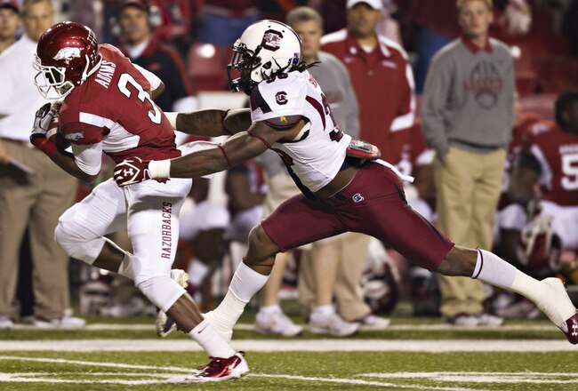 FAYETTEVILLE, AR - NOVEMBER 5:   Joe Adams #3 of the Arkansas Razorbacks is tackled from behind by D.J. Swearinger #36 of the South Carolina Gamecocks at Donald W. Reynolds Stadium on November 5, 2011in Fayetteville, Arkansas.  The Razorbacks defeated the Gamecocks 44 to 28.  (Photo by Wesley Hitt/Getty Images)