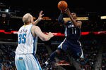 NEW ORLEANS, LA - JANUARY 18:  Mike Conley #11 of the Memphis Grizzlies shoots the ball over Chris Kaman #35 of the New Orleans Hornets at New Orleans Arena on January 18, 2012 in New Orleans, Louisiana.  NOTE TO USER: User expressly acknowledges and agrees that, by downloading and or using this photograph, User is consenting to the terms and conditions of the Getty Images License Agreement.  (Photo by Chris Graythen/Getty Images)