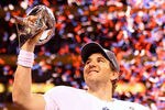 INDIANAPOLIS, IN - FEBRUARY 05:  Eli Manning #10 of the New York Giants hoist the Vince Lombardi Trophy after defeating the New England Patriots in Super Bowl XLVI at Lucas Oil Stadium on February 5, 2012 in Indianapolis, Indiana. The New York Giants defeated the New England Patriots 21-17.  (Photo by Al Bello/Getty Images)