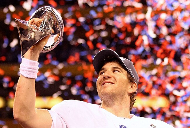 INDIANAPOLIS, IN - FEBRUARY 05:  Eli Manning #10 of the New York Giants hoist the Vince Lombardi Trophy after defeating the New England Patriots in Super Bowl XLVI at Lucas Oil Stadium on February 5, 2012 in Indianapolis, Indiana. The New York Giants defeated the New England Patriots 21-17.  (Photo by Al Bello/Getty Images)