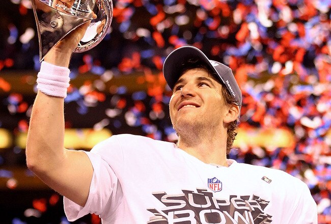 INDIANAPOLIS, IN - FEBRUARY 05:  Eli Manning #10 of the New York Giants hoist the Vince Lombardi Trophy after defeating the New England Patriots in Super Bowl XLVI at Lucas Oil Stadium on February 5, 2012 in Indianapolis, Indiana. The New York Giants defeated the New England Patriots 21-17.  (Photo by Al Bello/Getty Images)