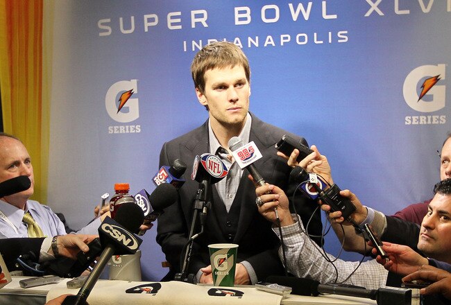 INDIANAPOLIS, IN - FEBRUARY 05:  Quarterback Tom Brady #12 of the New England Patriots speaks to the media after losing to the New York Giants in Super Bowl XLVI at Lucas Oil Stadium on February 5, 2012 in Indianapolis, Indiana. The New York Giants defeated the New England Patriots 21-17.  (Photo by Jamie Squire/Getty Images)