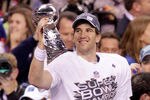 INDIANAPOLIS, IN - FEBRUARY 05:  Eli Manning #10 of the New York Giants hoist the Vince Lombardi Trophy after defeating the New England Patriots in Super Bowl XLVI at Lucas Oil Stadium on February 5, 2012 in Indianapolis, Indiana. The New York Giants defeated the New England Patriots 21-17.  (Photo by Joe Robbins/Getty Images)