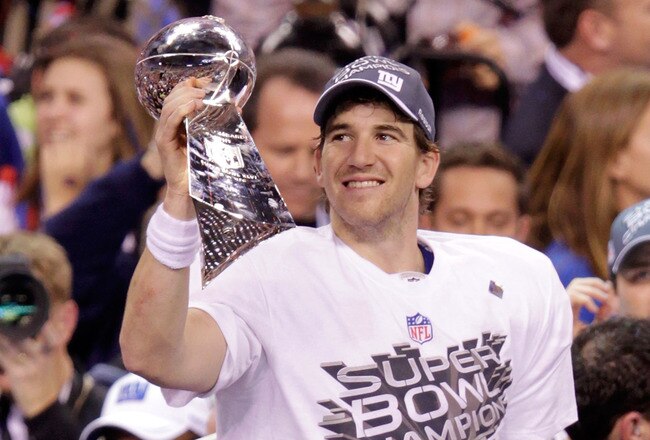 INDIANAPOLIS, IN - FEBRUARY 05:  Eli Manning #10 of the New York Giants hoist the Vince Lombardi Trophy after defeating the New England Patriots in Super Bowl XLVI at Lucas Oil Stadium on February 5, 2012 in Indianapolis, Indiana. The New York Giants defeated the New England Patriots 21-17.  (Photo by Joe Robbins/Getty Images)