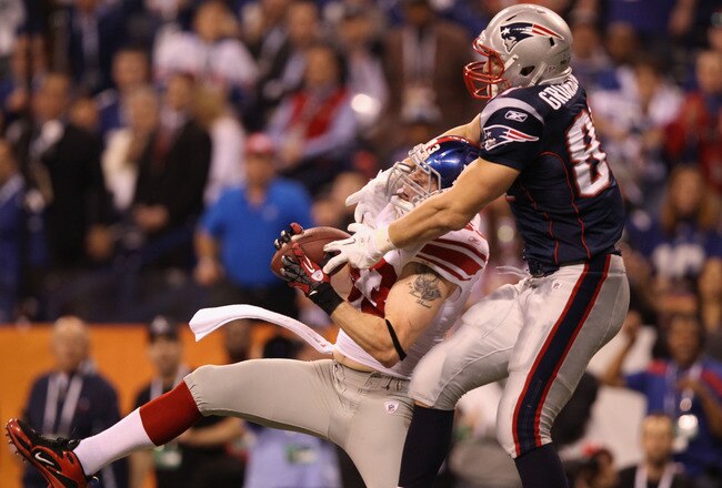 INDIANAPOLIS, IN - FEBRUARY 05:  Chase Blackburn #93 of the New York Giants intercepts a pass intended for Rob Gronkowski #87 of the New England Patriots in the second half during Super Bowl XLVI at Lucas Oil Stadium on February 5, 2012 in Indianapolis, Indiana.  (Photo by Ezra Shaw/Getty Images)