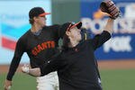 SAN FRANCISCO - OCTOBER 25:  Tim Lincecum #55 of the San Francisco Giants throws alongside teammate Matt Cain #18 during a team workout at AT&T Park on October 25, 2010 in San Francisco, California. The Giants are preparing to face the Texas Rangers in the 2010 World Series.  (Photo by Justin Sullivan/Getty Images)