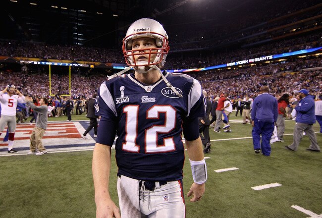 INDIANAPOLIS, IN - FEBRUARY 05:  Tom Brady #12 of the New England Patriots walks off the field after losing to the New York Giants by a score of 21-17 in Super Bowl XLVI at Lucas Oil Stadium on February 5, 2012 in Indianapolis, Indiana.  (Photo by Ezra Shaw/Getty Images)