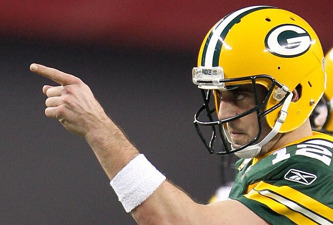 ARLINGTON, TX - FEBRUARY 06:  Quarterback Aaron Rodgers #12 of the Green Bay Packers points against the Pittsburgh Steelers during Super Bowl XLV at Cowboys Stadium on February 6, 2011 in Arlington, Texas.  (Photo by Jamie Squire/Getty Images)