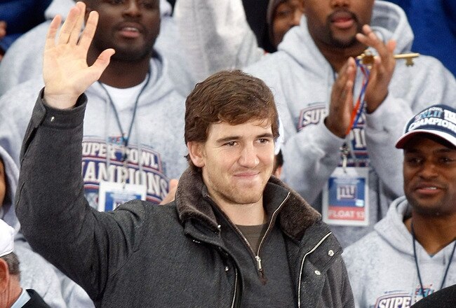 NEW YORK - FEBRUARY 05:  Quarterback Eli Manning waves to the crowd during the New York Giants Super Bowl XLII victory parade reception at City Hall February 5, 2008 in New York City.  (Photo by Nick Laham/Getty Images)