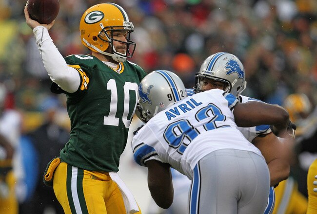 GREEN BAY, WI - JANUARY 01: Matt Flynn #10 of the Green Bay Packers throws a pass under pressure from Cliff Avril #92 and Ndamukong Suh #90 of the Detroit Lions at Lambeau Field on January 1, 2012 in Green Bay, Wisconsin. (Photo by Jonathan Daniel/Getty Images)
