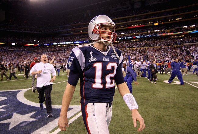 INDIANAPOLIS, IN - FEBRUARY 05:  Tom Brady #12 of the New England Patriots walks off the field after losing to the New York Giants by a score of 21-17 in Super Bowl XLVI at Lucas Oil Stadium on February 5, 2012 in Indianapolis, Indiana.  (Photo by Ezra Shaw/Getty Images)