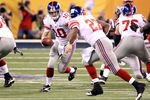 INDIANAPOLIS, IN - FEBRUARY 05:  Quarterback Eli Manning #10 of the New York Giants looks to hand off the ball to runningback Brandon Jacobs #27 in the first quarter against the New England Patriots during Super Bowl XLVI at Lucas Oil Stadium on February 5, 2012 in Indianapolis, Indiana.  (Photo by Andy Lyons/Getty Images)