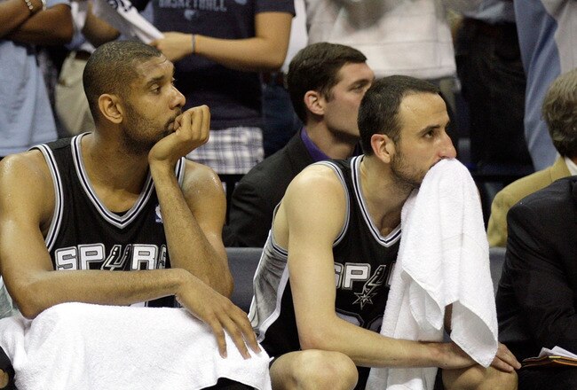 MEMPHIS, TN - APRIL 25: George Hill #3, Tim Duncan #21 and Manu Ginobili #20 of the San Antonio Spurs watch from the bench in the fourth quarter during the game against the Memphis Grizzlies in Game Four of the Western Conference Quarterfinals in the 2011 NBA Playoffs at FedExForum on April 25, 2011 in Memphis, Tennessee. The Grizzlies won 104-86. NOTE TO USER: User expressly acknowledges and agrees that, by downloading and/or using this Photograph, User is consenting to the terms and conditions of the Getty Images License Agreement.  (Photo by Andy Lyons/Getty Images)