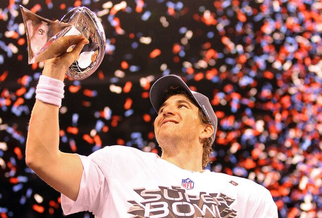 INDIANAPOLIS, IN - FEBRUARY 05:  Quarterback Eli Manning #10 of the New York Giants poses with the Vince Lombardi Trophy after the Giants defeated the Patriots by a score of 21-17 in Super Bowl XLVI at Lucas Oil Stadium on February 5, 2012 in Indianapolis, Indiana.  (Photo by Ezra Shaw/Getty Images)