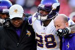 LANDOVER, MD - DECEMBER 24: Running back Adrian Peterson #28 of the Minnesota Vikings is helped off the field after being injured in the third quarter against the Washington Redskins at FedEx Field on December 24, 2011 in Landover, Maryland. (Photo by Patrick Smith/Getty Images)