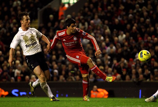 LIVERPOOL, ENGLAND - FEBRUARY 06:  Luis Suarez of Liverpool shoots under pressure from Scott Parker of Tottenham Hotspur during the Barclays Premier League match between Liverpool and Tottenham Hotspur at Anfield on February 6, 2012 in Liverpool, England.  (Photo by Clive Brunskill/Getty Images)