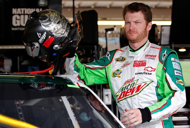 AVONDALE, AZ - NOVEMBER 11: Dale Earnhardt Jr., driver of the #88 Retro Diet Mountain Dew/National Guard Chevrolet, grabs his helmet in the garage prior to practice for the NASCAR Sprint Cup Series Kobalt Tools 500 at Phoenix International Raceway on November 11, 2011 in Avondale, Arizona.  (Photo by Geoff Burke/Getty Images for NASCAR)
