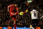 LIVERPOOL, ENGLAND - FEBRUARY 06:  Luis Suarez of Liverpool shoots and misses under pressure from Scott Parker of Tottenham Hotspur during the Barclays Premier League match between Liverpool and Tottenham Hotspur at Anfield on February 6, 2012 in Liverpool, England.  (Photo by Clive Brunskill/Getty Images)
