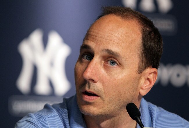 NEW YORK, NY - JULY 08:  General manager Brian Cashman of the New York Yankees speaks to the media after the game against the Tampa Bay Rays was postponed due to rain on July 8, 2011 at Yankee Stadium in the Bronx borough of New York City.  (Photo by Jim McIsaac/Getty Images)