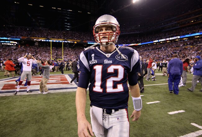 INDIANAPOLIS, IN - FEBRUARY 05:  Tom Brady #12 of the New England Patriots walks off the field after losing to the New York Giants by a score of 21-17 in Super Bowl XLVI at Lucas Oil Stadium on February 5, 2012 in Indianapolis, Indiana.  (Photo by Ezra Shaw/Getty Images)
