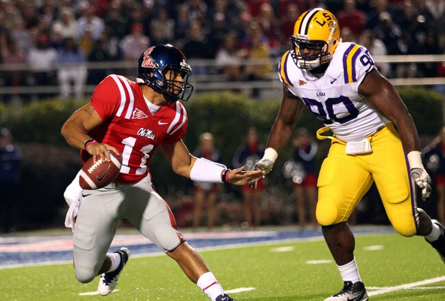 OXFORD, MS - NOVEMBER 19: Barry Brunetti #11 of the Ole Miss Rebels scrambles with the ball against Michael Brockers #90 of the LSU Tigers on November 19, 2011 at Vaught-Hemingway Stadium in Oxford, Mississippi.  (Photo by Joe Murphy/Getty Images)