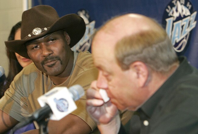 SALT LAKE CITY - FEBRUARY 13:  Karl Malone listens to Utah Jazz owner, Larry Miller, speak as he wipes tears from his eyes during his retirement announcement from playing NBA basketball on February 13, 2005 at the Delta Center in Salt Lake City, Utah. Malone played 19 years in the NBA, 18 with the Utah Jazz and his last year with the Los Angeles Lakers. Malone is currently second on the all time scoring list.  (Photo by George Frey/Getty Images)