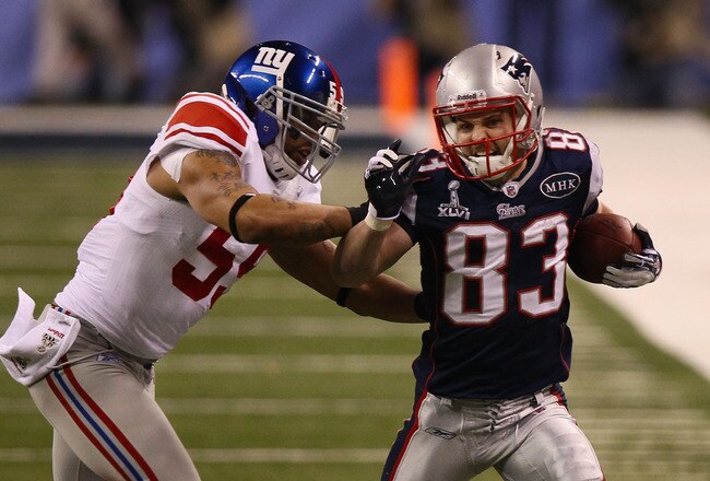 INDIANAPOLIS, IN - FEBRUARY 05:  Wes Welker #83 of the New England Patriots fights off the tackle of Michael Boley #59 of the New York Giants  in the first half during Super Bowl XLVI at Lucas Oil Stadium on February 5, 2012 in Indianapolis, Indiana.  (Photo by Win McNamee/Getty Images)