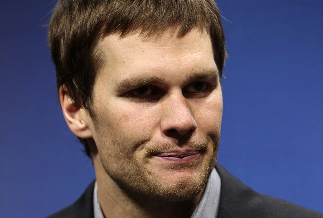 INDIANAPOLIS, IN - FEBRUARY 05:  Quarterback Tom Brady #12 of the New England Patriots speaks to the media after losing to the New York Giants in Super Bowl XLVI at Lucas Oil Stadium on February 5, 2012 in Indianapolis, Indiana. The New York Giants defeated the New England Patriots 21-17.  (Photo by Jamie Squire/Getty Images)