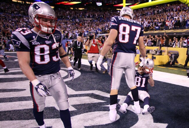 INDIANAPOLIS, IN - FEBRUARY 05:  Wes Welker #83, Rob Gronkowski #87 and Aaron Hernandez #81 of the New England Patriots wait in the end zone after losing to the New York Giants 21-17 during Super Bowl XLVI at Lucas Oil Stadium on February 5, 2012 in Indianapolis, Indiana.  (Photo by Elsa/Getty Images)