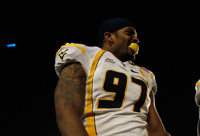 MIAMI GARDENS, FL - JANUARY 04:  (L-R) Julian Miller #97 and Bruce Irvin #11 of the West Virginia Mountaineers celebrate against the Clemson Tigers during the Discover Orange Bowl at Sun Life Stadium on January 4, 2012 in Miami Gardens, Florida.  (Photo by Streeter Lecka/Getty Images)