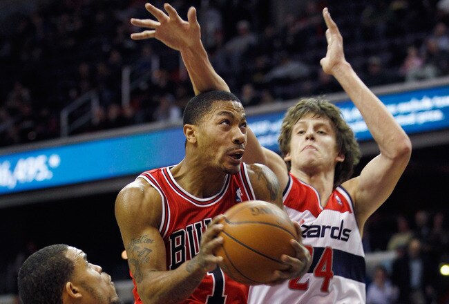 WASHINGTON, DC - JANUARY 30: Derrick Rose #1 of the Chicago Bulls puts up a shot in front of JaVale McGee #34 and Jan Vesely #24 of the Washington Wizards during the first half at Verizon Center on January 30, 2012 in Washington, DC. NOTE TO USER: User expressly acknowledges and agrees that, by downloading and or using this photograph, User is consenting to the terms and conditions of the Getty Images License Agreement.  (Photo by Rob Carr/Getty Images)