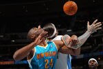 DENVER, CO - JANUARY 09:  Carl Landry #24 of the New Orleans Hornets and Chris Andersen #11 of the Denver Nuggets battle for a rebound at the Pepsi Center on January 9, 2012 in Denver, Colorado. NOTE TO USER: User expressly acknowledges and agrees that, by downloading and or using this photograph, User is consenting to the terms and conditions of the Getty Images License Agreement.  (Photo by Doug Pensinger/Getty Images)