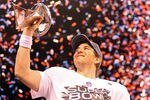 INDIANAPOLIS, IN - FEBRUARY 05:  Quarterback Eli Manning #10 of the New York Giants poses with the Vince Lombardi Trophy after the Giants defeated the Patriots by a score of 21-17 in Super Bowl XLVI at Lucas Oil Stadium on February 5, 2012 in Indianapolis, Indiana.  (Photo by Ezra Shaw/Getty Images)